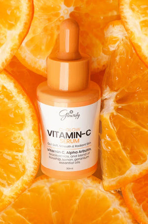Glowrify Vitamin C Serum with orange slices, featuring Vitamin C, Alpha Arbutin, and essential oils for radiant skin