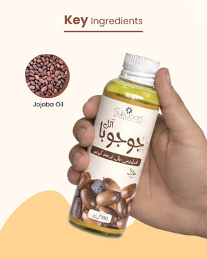 Hand holding bottle of pure jojoba oil, key ingredient for natural skincare and wellness