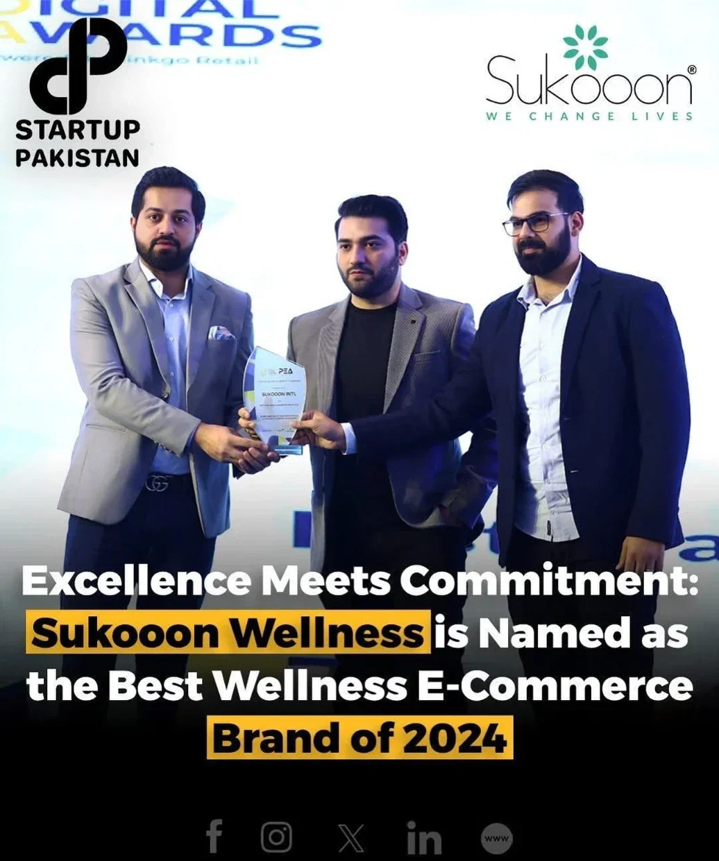 Three men in formal wear holding a best wellness e-commerce brand award at a digital awards event.