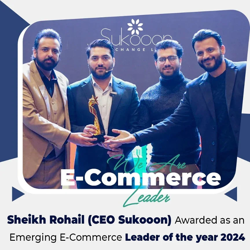 Four men in formal wear receiving an e-commerce award on stage with a trophy