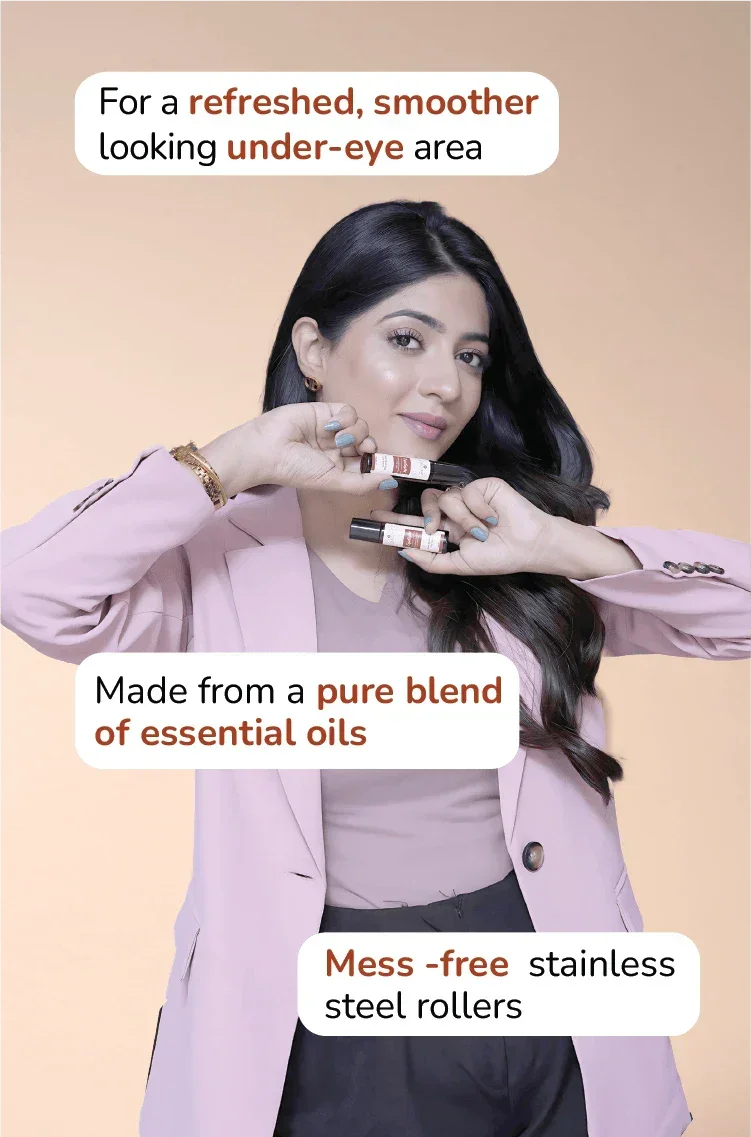 Woman holding essential oil under-eye rollers with stainless steel applicators for refreshed, smoother skin