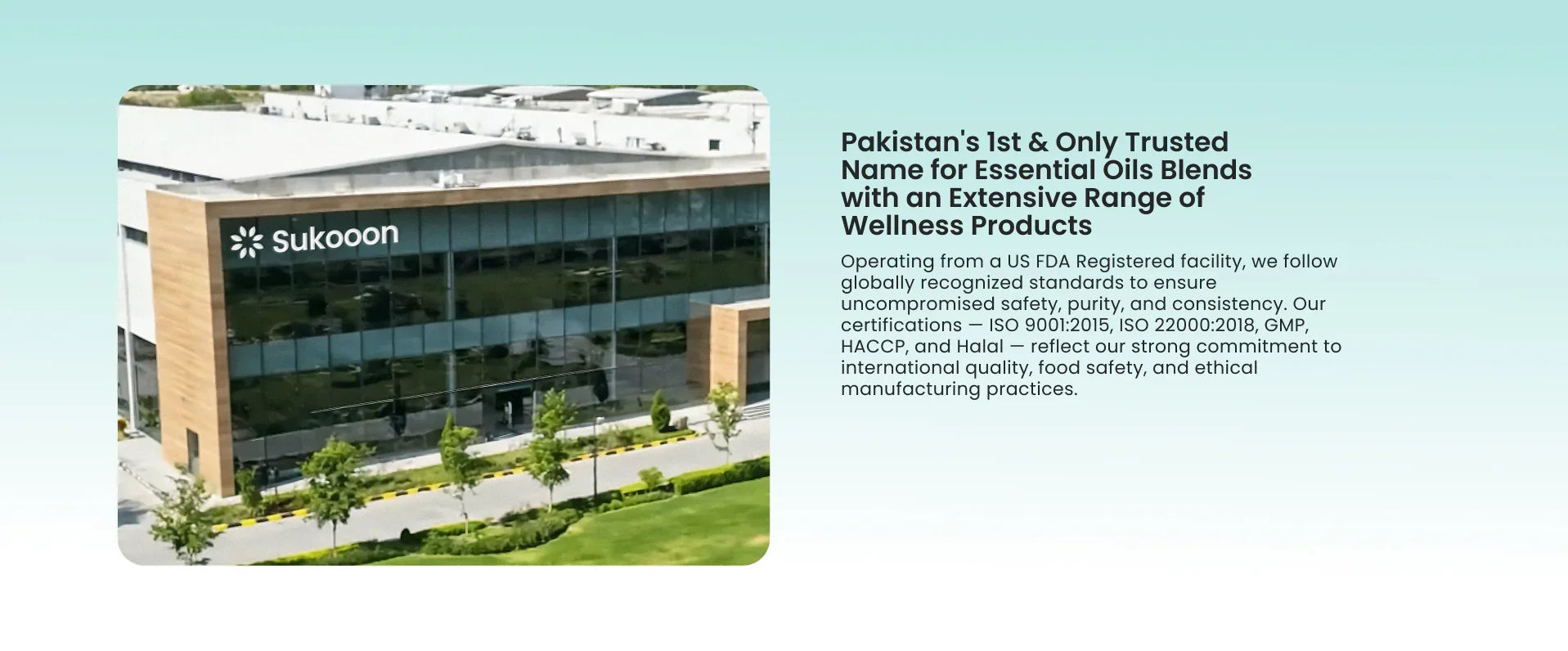 Modern glass and wood building with Sukooon logo, showcasing certified wellness product manufacturing facility