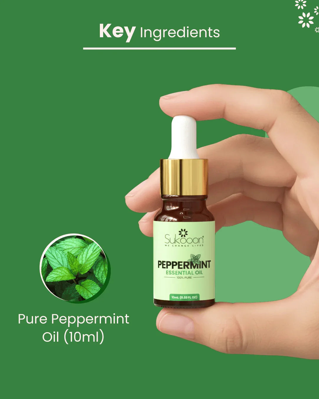Hand holding 10ml bottle of pure peppermint essential oil with dropper, green background, fresh mint leaves inset