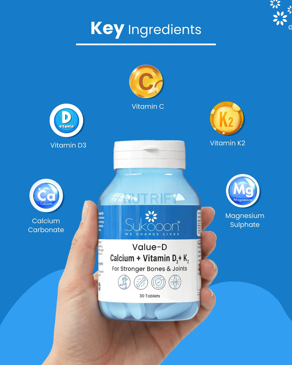 Hand holding Sukooon Value-D calcium + vitamin D3 + K2 supplement for stronger bones and joints, with key ingredients highlighted.
